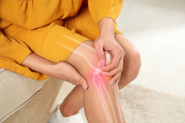 Sick woman at home, closeup. Digital compositing with illustration of knee joint